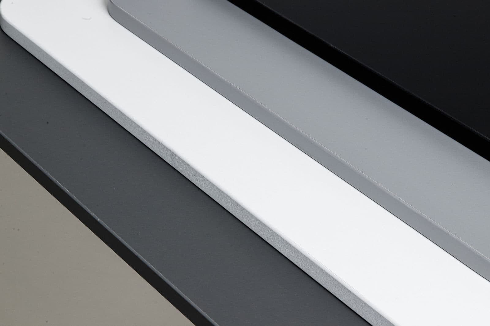 Desko laminate desktops in white, grey and black fanned out